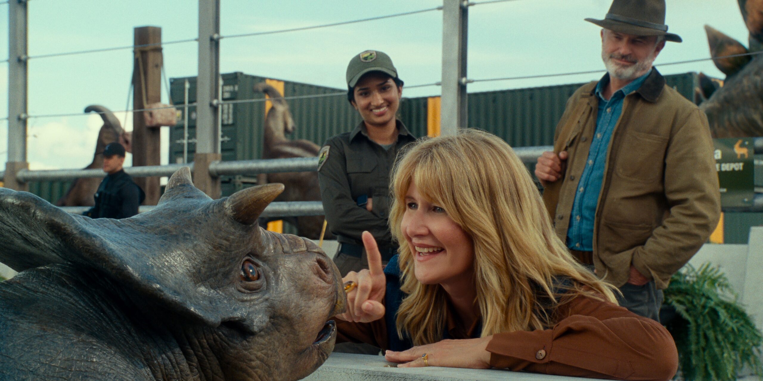 Baby dinosaur and woman look at each other in Jurassic World Dominion