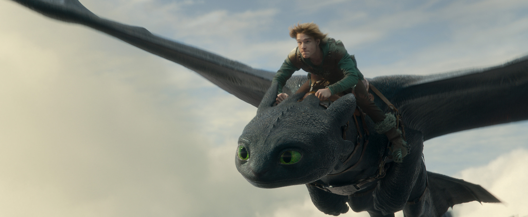 Toothless the dragon flies with Hiccup on his back in How to Train Your Dragon the 2025 live action film