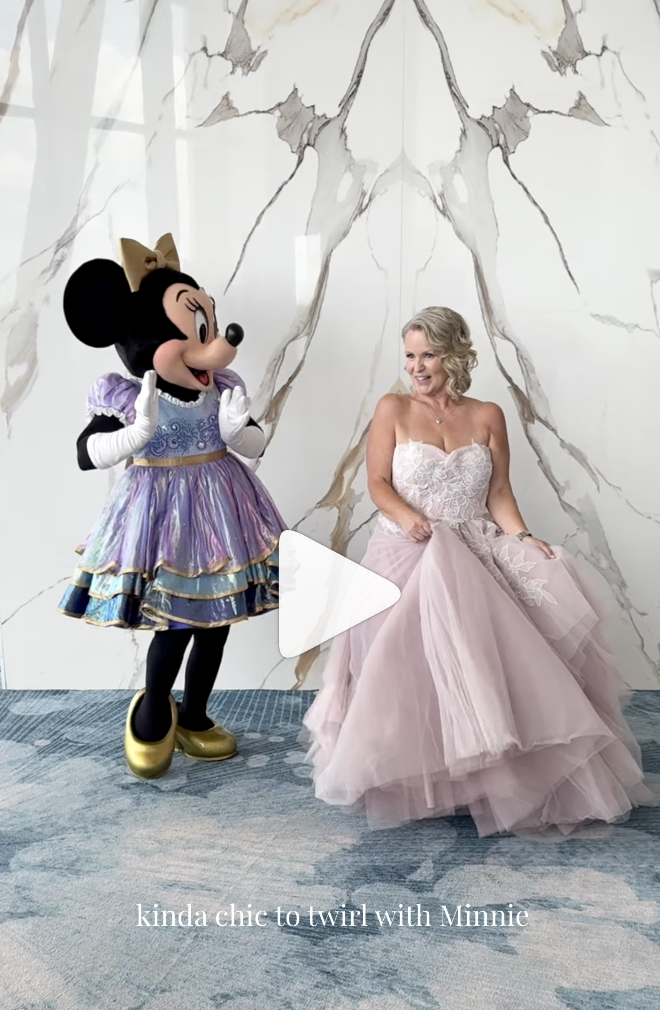 A Disney bride twirls with Minnie Mouse.